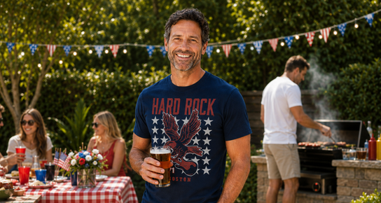 Man wearing a Hard Rock Americana tee at a backyard barbecue.